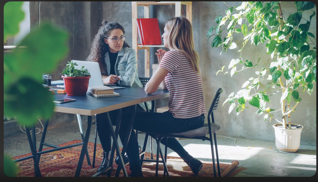 Two people discussing a learning plan during a consultation